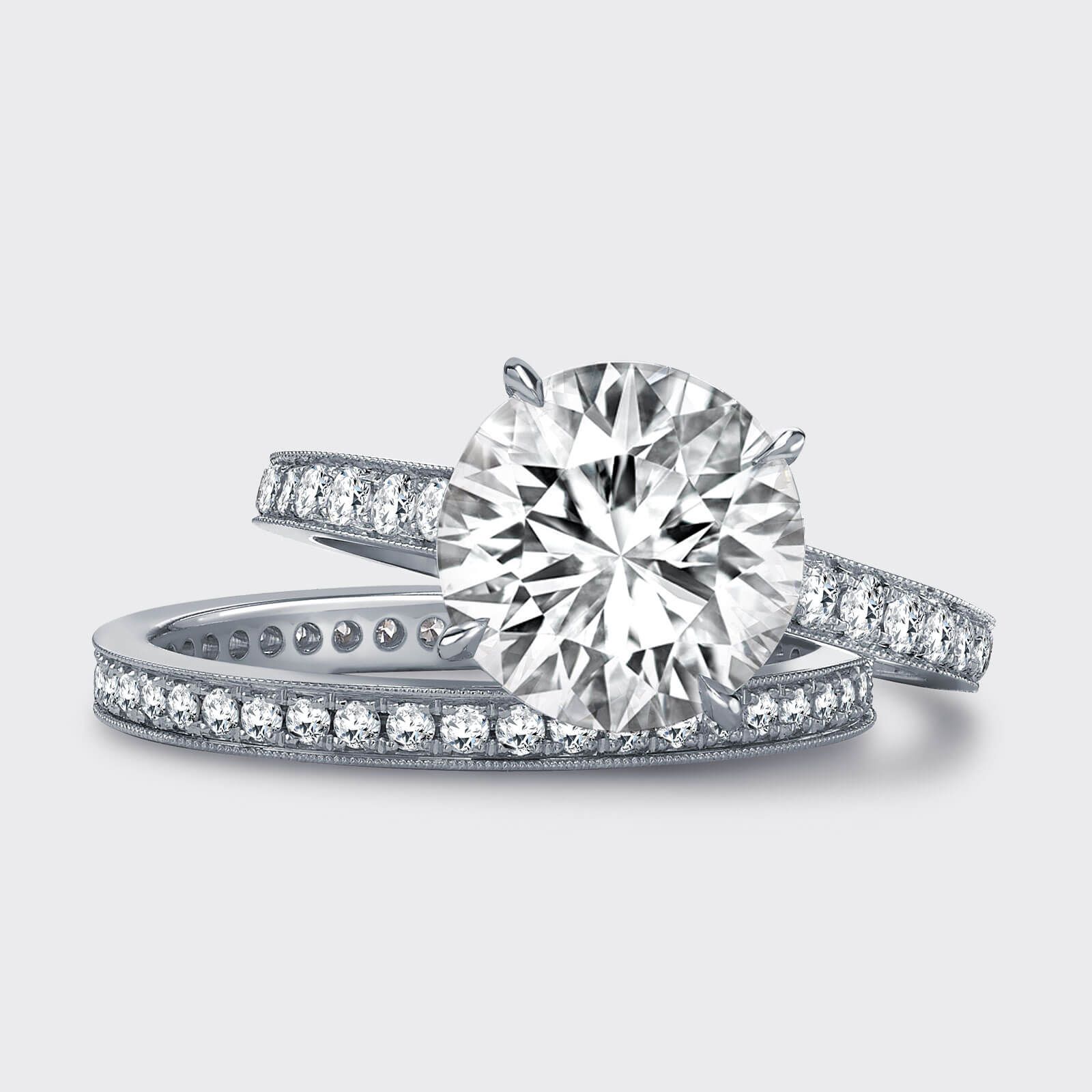 Close up of a Garrard bridal jewellery collection diamond wedding bands and a round diamond engagement ring square