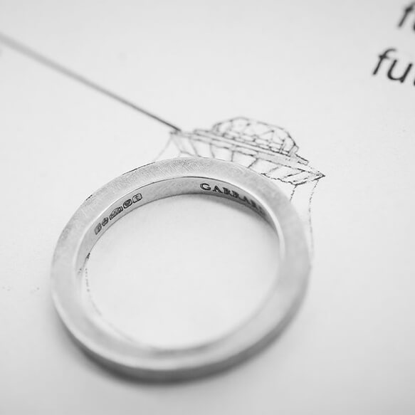 Close up of a Garrard ring with the design sketch