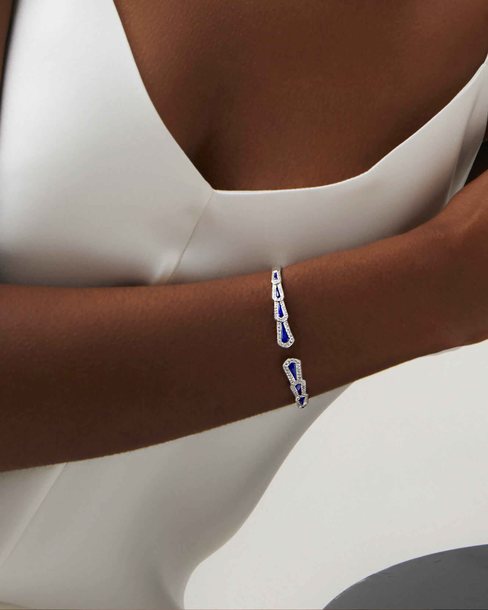 Close up of a model wearing the Garrard Fanfare collection diamond bangle