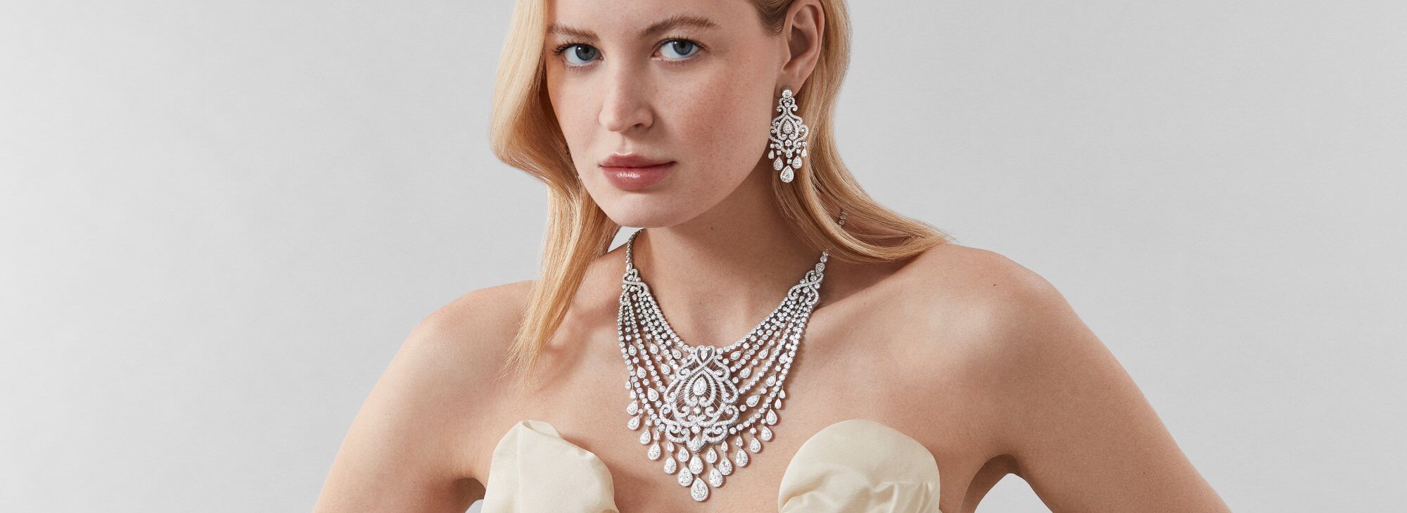 Model wears Garrard White Rose High Jewellery Suite